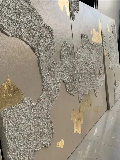 The texture on these panels is designed to look like weathered, ancient surfaces, with the gold leaf appearing like a precious discovery.