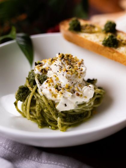Hosting a party? Our catering menu includes more than just pizza, like this beautiful pesto pasta with stracciatella.
