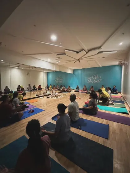 A wide shot of a sound healing session in progress. You can see the participants settled on their mats as I guide them from the center of the room, creating a collective field of tranquility.