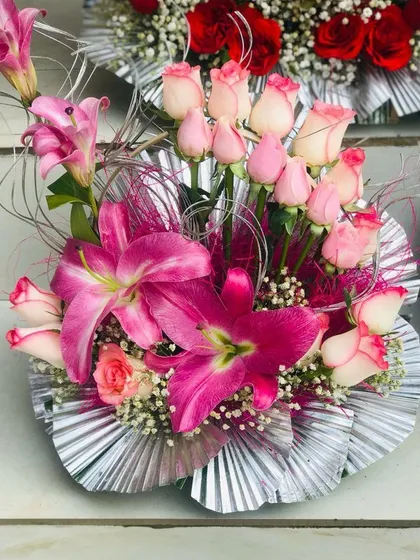 This special occasion bouquet combines pink lilies and roses with decorative silver elements for a more formal look. It's a popular design for Valentine's Day and anniversaries.