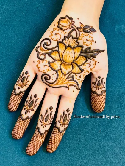 A stunning lotus design on the back of the hand. The use of shading and negative space makes the flower look almost three-dimensional.