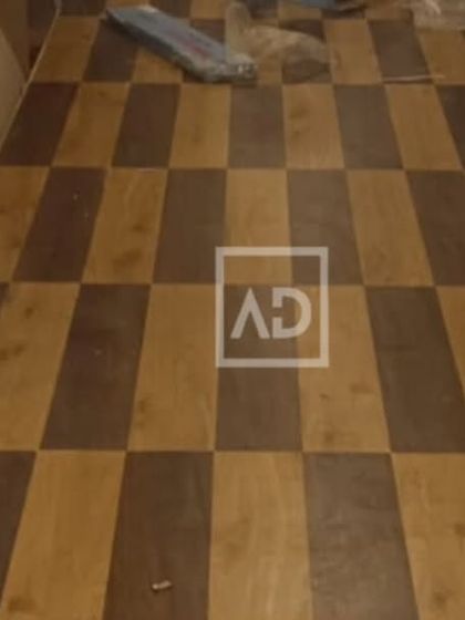 A custom checkerboard pattern created using two different shades of wooden flooring planks. This is a great way to add a unique design element to any space.