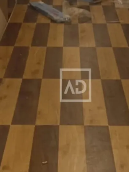 A custom checkerboard pattern created using two different shades of wooden flooring planks. This is a great way to add a unique design element to any space.