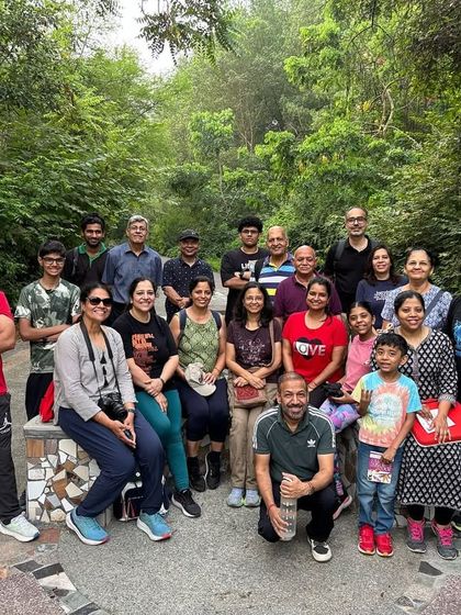 A happy group of families and individuals pose for a photo after a refreshing and educational community walk through our restored green corridor.