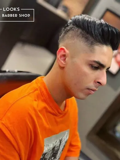 A high and tight fade with a voluminous top. This is a powerful, clean look that exudes confidence.