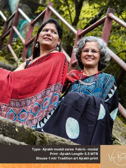 A lovely photo of two customers, one in a red Ajrakh saree and the other in a black version. It’s a beautiful showcase of friendship and shared love for ethnic wear.