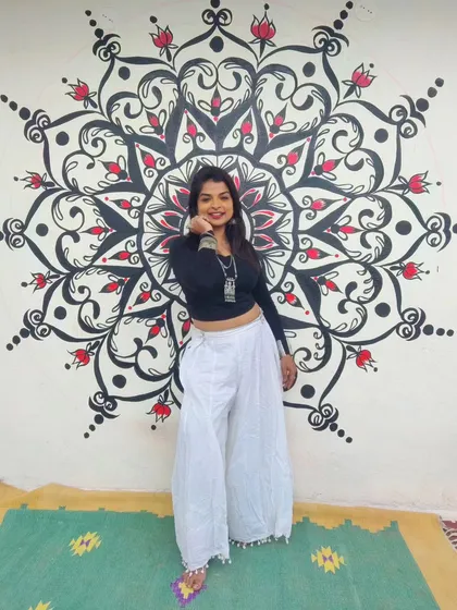 Here I am with a finished mandala mural I created for a client's party area. I design these pieces to be a focal point, using bold lines and intricate patterns to create a sense of balance and energy in the space. This is a great example of my custom mandala wall art.