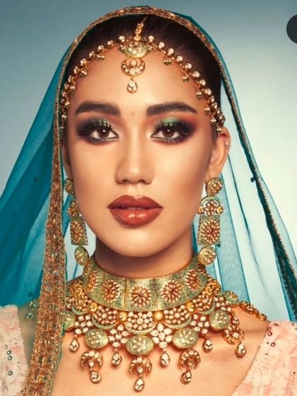 A high-fashion look featuring a mint meena Kundan bridal set against a vibrant blue dupatta. This shows the versatility and modern appeal of my collection.