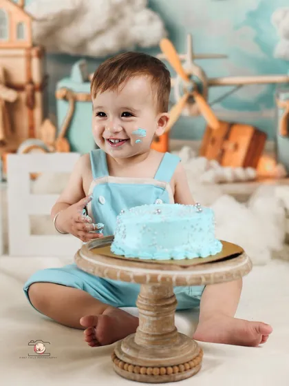 A close up of the birthday boy with a huge, cake filled smile. These are the wonderfully messy and joyful moments I love to capture in a cake smash session.