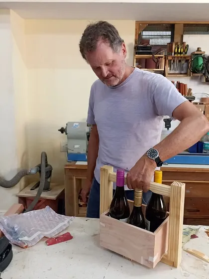 Chris designed and built this handsome wine caddy using plywood and pinewood. The handle is joined with a strong mortise and tenon, making it durable enough to carry three full bottles.