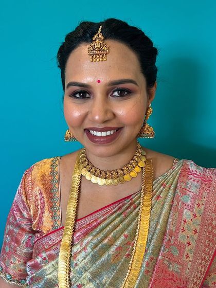 This photo captures the client's beautiful smile and the flawless finish of the makeup. My priority is always to ensure my clients feel like the best version of themselves.