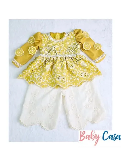 A beautiful yellow and white lace suit for a little girl. This elegant ethnic outfit is perfect for daytime festive events or a Haldi ceremony.