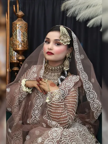A full portrait of the Walima bride. The makeup is soft, with a bold red lip.