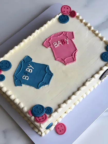 Sheet cakes are perfect for baby showers when you want to make sure everyone gets a piece. This design features cute fondant baby onesies and buttons, with plenty of room for a delicious slice for every guest.