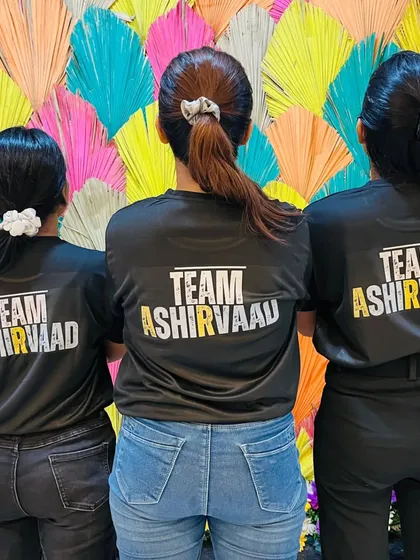 The back of our official team t-shirts. We are a unified team, proud to represent Team Ashirvaad at every rehearsal, event, and celebration.