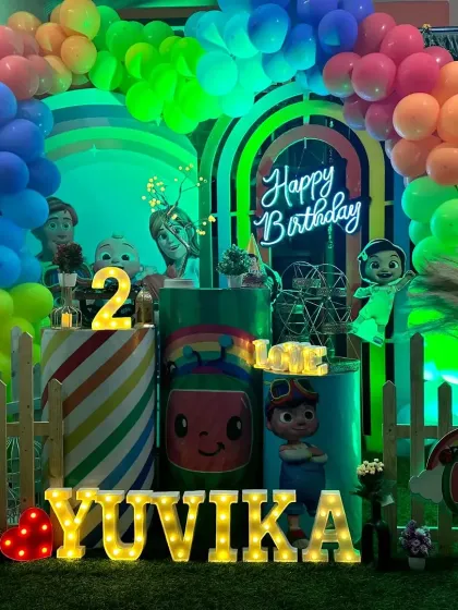 The vibrant rainbow balloon arch and glowing marquee letters make this Cocomelon theme for Yuvika's 2nd birthday a real showstopper.