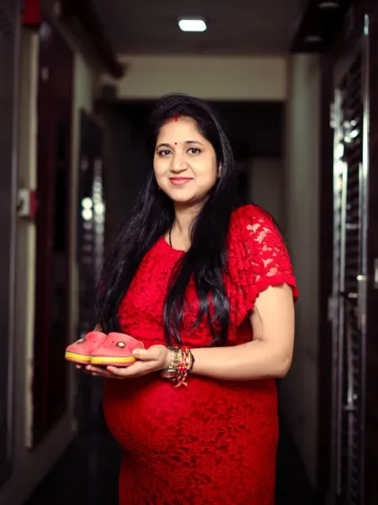 Holding a pair of tiny baby shoes is a classic and heartwarming pose for a maternity shoot. It symbolizes all the love and anticipation for the little one's arrival.
