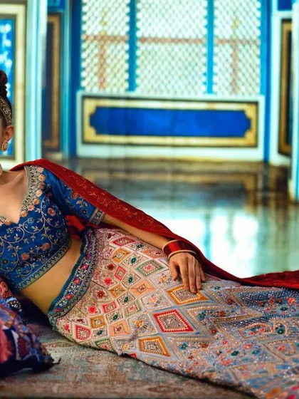 A luxurious room in a Mughal-inspired palace, created with projection. The vibrant blue walls and intricate details provide a stunning backdrop for this royal-themed bridal shoot.