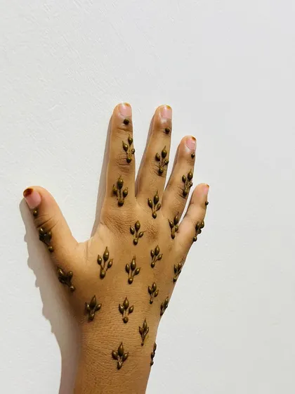 A clear shot of the scattered leaf design on a child's hand.