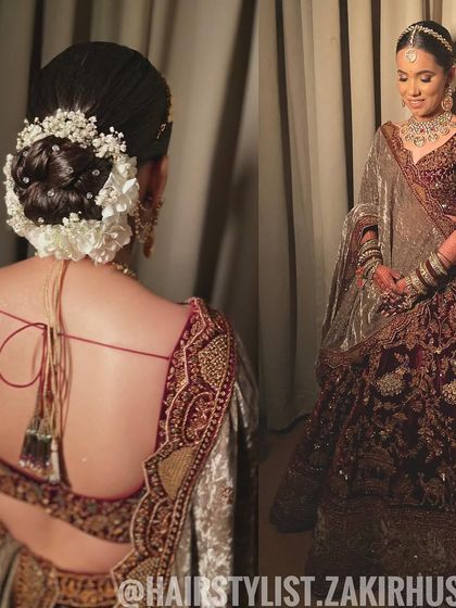 A full-length view of the bride with her floral bun, showcasing how the hairstyle complements her entire bridal ensemble.