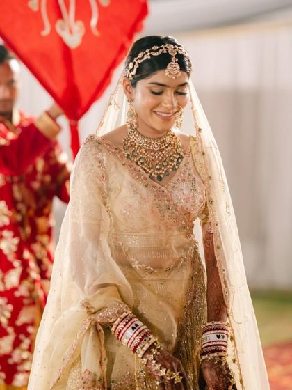 The bride's graceful entry, with her brothers holding a traditional red banner, is a moment filled with emotion and beauty.