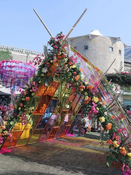 The floral and glass entrance arch from another angle, showing how it creates a stunning welcome for guests.