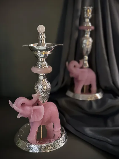 This traditional jyot or oil lamp is elevated with a carved rose quartz elephant base and intricate silver work. It brings together function and quiet beauty in one stunning silhouette.