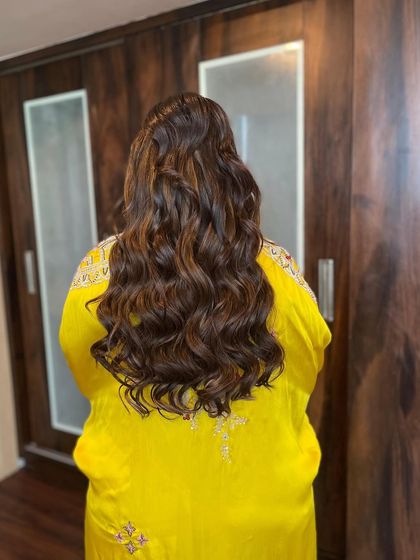 A back view of the voluminous waves created for this cocktail look. I use extensions to add length and fullness for that extra touch of drama.