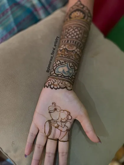 I love making your mehendi personal. Here, I created a custom portrait of the couple, a unique and sweet way to tell their love story right on the bride's palm.