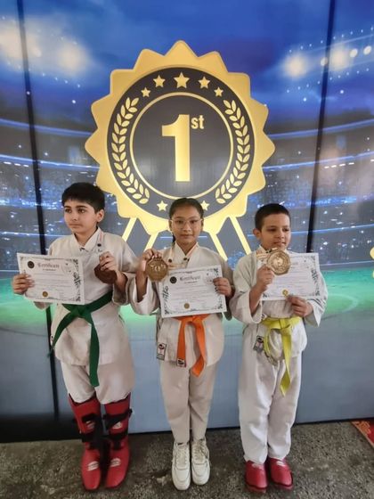 Three young champions standing on the winner's podium. This is a moment they will remember forever.