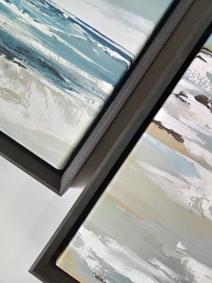 The raw power of the ocean is captured in this coastline artwork by Valeria Mravyan. A dark floater frame adds to the dramatic feel while keeping the focus on the textured brushstrokes.