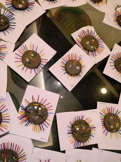 An army of finished clay suns, each one unique and full of personality. I love seeing the variety that comes from a single project prompt.