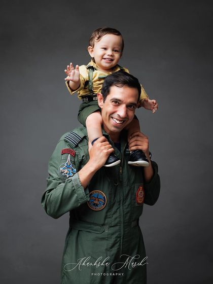 A father's shoulders are the best seat in the house. This playful shot from the Airforce family session is full of smiles and pure joy.