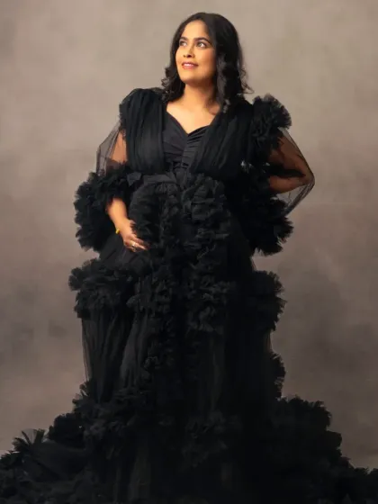 Bold and beautiful in black. This dramatic ruffled tulle gown makes a powerful statement, proving that glamour only grows during pregnancy.