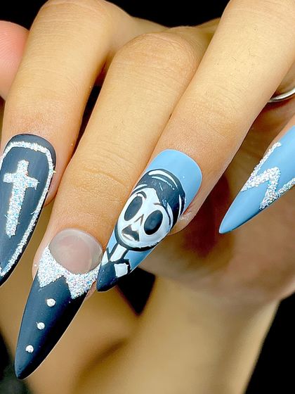 A client wearing our hand-painted Halloween nail art, showing how these fun, spooky designs look as a full set.