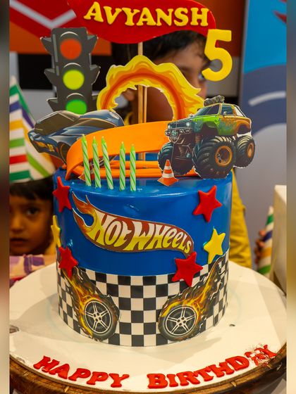 A close-up of the awesome Hot Wheels cake, complete with monster trucks, race cars, and a flaming track.