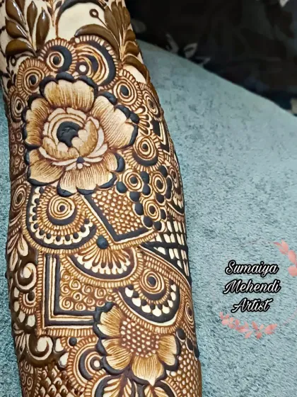A full arm floral henna design that is just breathtaking. The flowers and leaves flow so naturally up the arm.