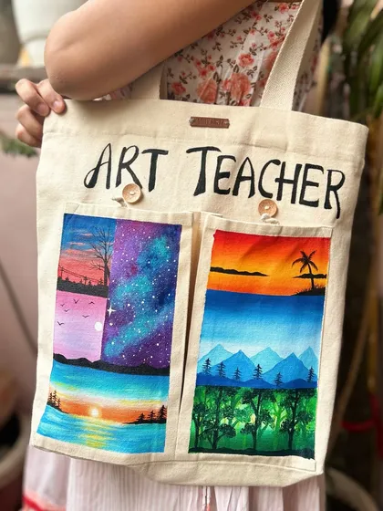 Here I am holding the finished custom-painted tote bag. It's a great example of a personalized, practical gift for any art lover or teacher. The design can be customized to whatever you like.
