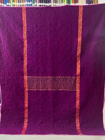 The reverse side of the same quilt, in a deep, royal purple.