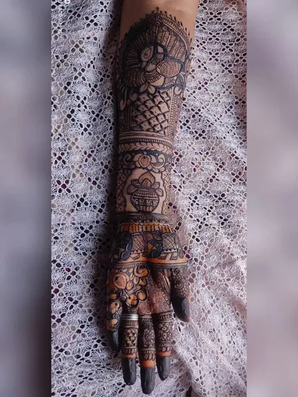 A single arm design featuring a peacock, a kalash, and other traditional Indian motifs.