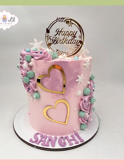 A lovely pink birthday cake for Sanchi, decorated with gold hearts and delicate piping.
