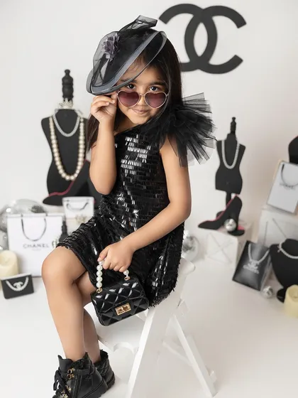 Serving looks in her Chanel-inspired fashion shoot. This theme is perfect for the little diva in your life, complete with designer props and a high-fashion attitude.