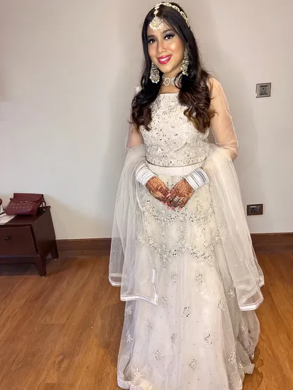 Yutika looking like a princess. The ivory lehenga is paired with dramatic silver eye makeup and traditional jewelry for a stunning fusion look.