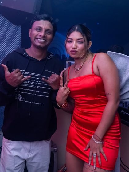 Posing with a fellow artist during a New Year's Eve event. I often collaborate with other performers to make the night even more special.