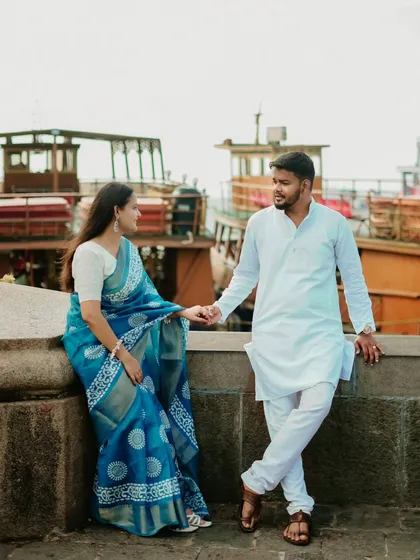 A romantic shot of Abhishek and Saloni by the Mumbai docks. Holding hands in their traditional attire, they look like the lead pair in a classic love story.