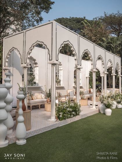 A long shot of the architectural lounge structure, showing how the repeating arches create a beautiful, semi-enclosed space for guests to gather.