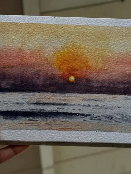 A serene watercolour sunset over the ocean. I used a wet-on-wet technique to blend the warm colours of the sky and reflect them in the water.