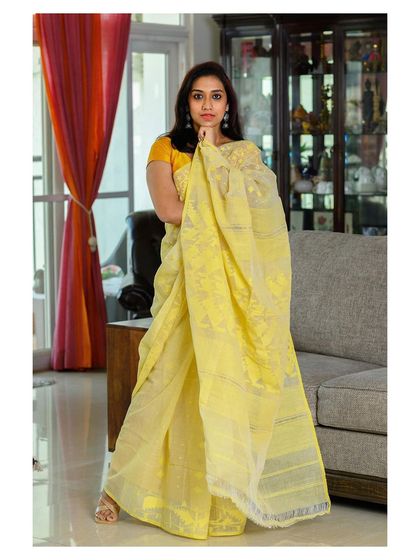 A full-length shot of the same yellow Jamdani saree, showing its light and airy texture.