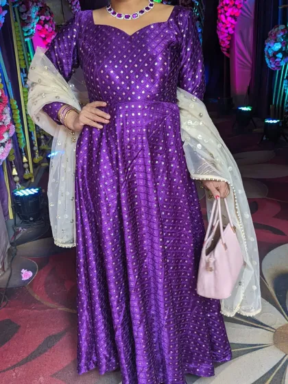 This purple premium Gajji silk Anarkali gown is perfect for both summer and winter weddings. It's a timeless, easy-to-carry Indo-Western outfit.