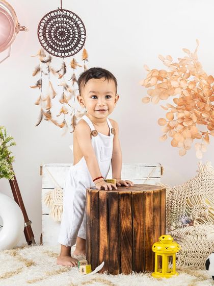 A standing shot of a baby boy in our boho-chic lifestyle set. Perfect for capturing those wobbly first steps.